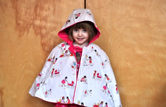 oliver + s red riding hood cape with children at play by sarah jane