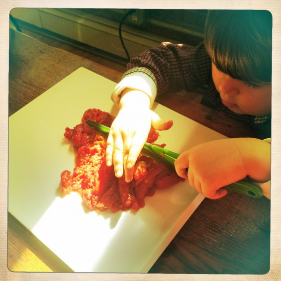 chopping up the roasted tomatoes