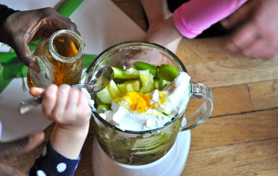 adding raw honey to a smoothie